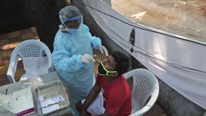 A health worker takes a nasal swab sample at a Covid-19 testing center in Hyderabad, India.(AP) A health worker takes a nasal swab sample at a Covid-19 testing center in Hyderabad, India.(AP)