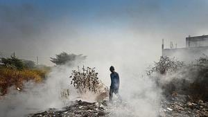 A boy walks through smoke emanating from garbage set on fire in Bhalswa in New Delhi. The national capital reported an AQI of 312, in the ‘very poor’ category, on Tuesday. A boy walks through smoke emanating from garbage set on fire in Bhalswa in New Delhi. The national capital reported an AQI of 312, in the ‘very poor’ category, on Tuesday.
