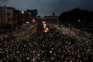 In this October 19, 2020, file photo, pro-democracy activists wave mobile phones with lights during a demonstration at Kaset intersection, suburbs of Bangkok, Thailand (AP Photo/Sakchai Lalit, File) In this October 19, 2020, file photo, pro-democracy activists wave mobile phones with lights during a demonstration at Kaset intersection, suburbs of Bangkok, Thailand (AP Photo/Sakchai Lalit, File)