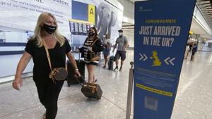 Passengers at London’s Heathrow Airport (Yui Mok/PA via AP) Passengers at London’s Heathrow Airport (Yui Mok/PA via AP)
