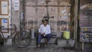 A man sits outside a closed store in Mumbai.(Bloomberg File Photo) A man sits outside a closed store in Mumbai.(Bloomberg File Photo)