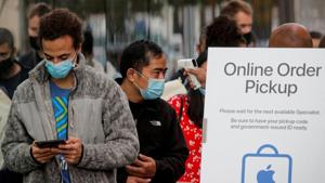 A customer has his temperature taken while in line outside an Apple Store to pick up Apple's new 5G iPhone 12, as the coronavirus disease (Covid-19) outbreak continues in Brooklyn, New York on October 23, 2020.(Reuters File Photo) A customer has his temperature taken while in line outside an Apple Store to pick up Apple's new 5G iPhone 12, as the coronavirus disease (Covid-19) outbreak continues in Brooklyn, New York on October 23, 2020.(Reuters File Photo)