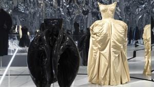 This image released by the Metropolitan Museum of Art in New York shows a black dress by Dutch designer Iris Van Herpen, left, and a ball gown by American designer Charles James, part of The Costume Institute’s exhibition This image released by the Metropolitan Museum of Art in New York shows a black dress by Dutch designer Iris Van Herpen, left, and a ball gown by American designer Charles James, part of The Costume Institute’s exhibition
