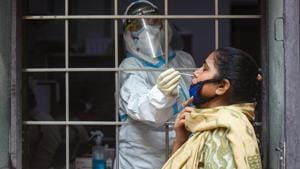 A health worker in PPE coveralls collects a swab samples for coronavirus test at Amar Colony in New Delhi on Thursday.(Amal KS/HT Photo) A health worker in PPE coveralls collects a swab samples for coronavirus test at Amar Colony in New Delhi on Thursday.(Amal KS/HT Photo)
