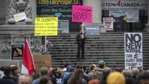 Protesters opposed to Covid-19 regulations hold signs and listen to speeches during a rally, in Vancouver, British Columbia.(AP) Protesters opposed to Covid-19 regulations hold signs and listen to speeches during a rally, in Vancouver, British Columbia.(AP)