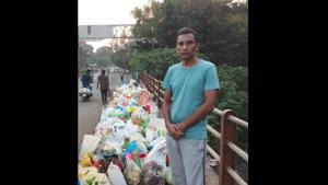 Chandra Kishore Patil standing beside bags of waste.(Twitter) Chandra Kishore Patil standing beside bags of waste.(Twitter)