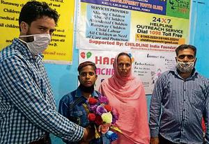 Poonch deputy commissioner Rahul Yadav with the minor boy and his family.(HT Photo) Poonch deputy commissioner Rahul Yadav with the minor boy and his family.(HT Photo)