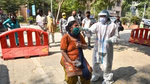 A healthcare worker in PPE coveralls collects a swab sample from a woman for coronavirus testing, at Hari Nagar in New Delhi on Saturday.(Sanchit Khanna/HT Photo) A healthcare worker in PPE coveralls collects a swab sample from a woman for coronavirus testing, at Hari Nagar in New Delhi on Saturday.(Sanchit Khanna/HT Photo)