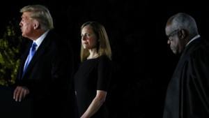 Judge Amy Coney Barrett being sworn in to serve as an associate justice of the US Supreme Court by Justice Clarence Thomas on the South Lawn of the White House.(REUTERS) Judge Amy Coney Barrett being sworn in to serve as an associate justice of the US Supreme Court by Justice Clarence Thomas on the South Lawn of the White House.(REUTERS)