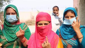 Women voters show their inked fingers at a polling station after casting their vote for Baroda By-polls.(HT photo)