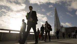 Commuters cross London Bridge in view of The Shard in London on November 2 ahead of a partial lockdown in UK.(Bloomberg) Commuters cross London Bridge in view of The Shard in London on November 2 ahead of a partial lockdown in UK.(Bloomberg)