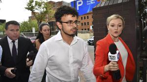 Arsalan Tariq Khawaja, center, is seen at Parramatta Police Station in Sydney, Tuesday, Dec. 4, 2018.(AP) Arsalan Tariq Khawaja, center, is seen at Parramatta Police Station in Sydney, Tuesday, Dec. 4, 2018.(AP)