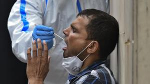 A man gives a swab sample for coronavirus detection tests, at Nehru Homoeopathic Medical College and Hospital in Defense Colony, New Delhi on Thursday.(Biplov Bhuyan/HT PHOTO) A man gives a swab sample for coronavirus detection tests, at Nehru Homoeopathic Medical College and Hospital in Defense Colony, New Delhi on Thursday.(Biplov Bhuyan/HT PHOTO)