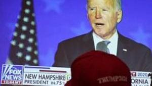A President Donald Trump supporter watches as Democratic presidential candidate former Vice President Joe Biden speaks on a television at a Republican election night watch party.(AP photo) A President Donald Trump supporter watches as Democratic presidential candidate former Vice President Joe Biden speaks on a television at a Republican election night watch party.(AP photo)