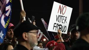 Some of the roughly 200 mostly unmasked protesters, who were faced by a line of armed county sheriffs said they came out after a tweet from Mike Cernovich, a right-wing activist(AFP) Some of the roughly 200 mostly unmasked protesters, who were faced by a line of armed county sheriffs said they came out after a tweet from Mike Cernovich, a right-wing activist(AFP)