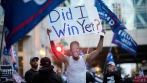 A Donald Trump supporter carries a sign while wearing a mask of US Democratic presidential nominee Joe Biden during a protest outside of the Philadelphia Convention Center, where votes are still being counted two days after the presidential election, in Philadelphia, Pennsylvania, US, November 5, 2020 (REUTERS/Mark Makela) A Donald Trump supporter carries a sign while wearing a mask of US Democratic presidential nominee Joe Biden during a protest outside of the Philadelphia Convention Center, where votes are still being counted two days after the presidential election, in Philadelphia, Pennsylvania, US, November 5, 2020 (REUTERS/Mark Makela)
