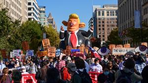 A balloon depicting US President Donald Trump is seen, as protesters march toward the White House, following the 2020 US presidential election, in Washington.(REUTERS) A balloon depicting US President Donald Trump is seen, as protesters march toward the White House, following the 2020 US presidential election, in Washington.(REUTERS)