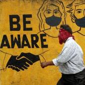 A man walks past a graffiti amid the spread of the coronavirus disease in Mumbai on November 2, 2020.(REUTERS) A man walks past a graffiti amid the spread of the coronavirus disease in Mumbai on November 2, 2020.(REUTERS)