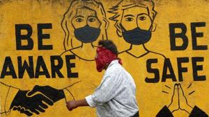A man walks past a graffiti amid the spread of the coronavirus disease (COVID-19) in Mumbai.(REUTERS) A man walks past a graffiti amid the spread of the coronavirus disease (COVID-19) in Mumbai.(REUTERS)