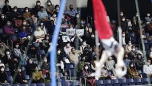 Audience members cheer for Wataru Tanigawa of Japan as he competes in the rings during an international gymnastics meet in Tokyo on Sunday, Nov. 8, 2020. Gymnasts from four countries of China, Russia, U.S. and Japan performed in the meet at Yoyogi National Stadium First Gymnasium, a venue planned to be used in the Tokyo 2020 Olympics in the summer 2021. (AP Photo/Hiro Komae)(AP) Audience members cheer for Wataru Tanigawa of Japan as he competes in the rings during an international gymnastics meet in Tokyo on Sunday, Nov. 8, 2020. Gymnasts from four countries of China, Russia, U.S. and Japan performed in the meet at Yoyogi National Stadium First Gymnasium, a venue planned to be used in the Tokyo 2020 Olympics in the summer 2021. (AP Photo/Hiro Komae)(AP)
