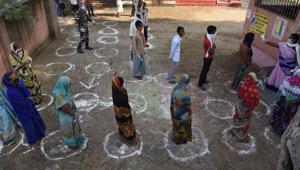 Voters stand in queues maintaining social distance at a polling station, during the first phase of state elections at Paliganj, in the eastern Indian state of Bihar, Wednesday, Oct. 28, 2020.(AP)