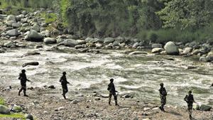 BSF soldiers patrol next to a stream near the Line of Control in Poonch district.(REUTERS) BSF soldiers patrol next to a stream near the Line of Control in Poonch district.(REUTERS)