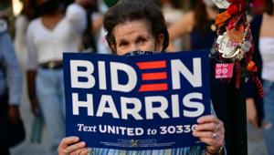 A Biden supporter holds a campaign sign, the day after a presidential election victory was called for former Vice President Joe Biden, in Philadelphia, Pennsylvania, US on November 8, 2020.(Reuters Photo) A Biden supporter holds a campaign sign, the day after a presidential election victory was called for former Vice President Joe Biden, in Philadelphia, Pennsylvania, US on November 8, 2020.(Reuters Photo)