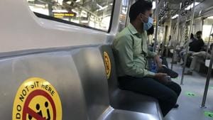 Commuters wearing face masks as a precautionary measure against the coronavirus and travel in a metro train which has markings to ensure social distancing in New Delhi on Sunday.(AP Photo) Commuters wearing face masks as a precautionary measure against the coronavirus and travel in a metro train which has markings to ensure social distancing in New Delhi on Sunday.(AP Photo)