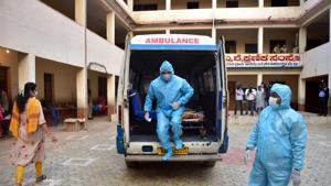 A Covid-19 patient arrives to cast his vote for the state by-polls, at Rajarajeshwari Nagar in Bengaluru.(PTI) A Covid-19 patient arrives to cast his vote for the state by-polls, at Rajarajeshwari Nagar in Bengaluru.(PTI)