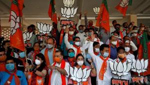 Supporters of Bharatiya Janata Party hold up party symbols and flags as they gather to celebrate the results of the Bihar assembly election on November 10.(REUTERS) Supporters of Bharatiya Janata Party hold up party symbols and flags as they gather to celebrate the results of the Bihar assembly election on November 10.(REUTERS)