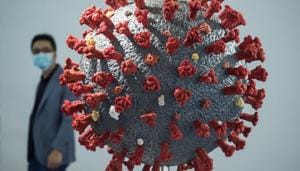 A man walks past a model of the COVID-19 coronavirus at the second World Health Expo in Wuhan, in China's central Hubei province, where the coronavirus was first detected in December 2019.(AFP)