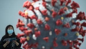 A woman looks at a model of the COVID-19 coronavirus at the second World Health Expo in Wuhan, in China's central Hubei province, where the coronavirus was first detected in December 2019.(AFP) A woman looks at a model of the COVID-19 coronavirus at the second World Health Expo in Wuhan, in China's central Hubei province, where the coronavirus was first detected in December 2019.(AFP)
