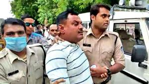 Police personnel arrest Vikas Dubey, the main accused in the Kanpur encounter case, at the Mahakal temple, in Ujjain.(ANI) Police personnel arrest Vikas Dubey, the main accused in the Kanpur encounter case, at the Mahakal temple, in Ujjain.(ANI)