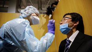 A medical worker wearing a protective suit conducts a simulation for a polymerase chain reaction (PCR) test at newly-opened Narita International Airport PCR Center operated by Nippon Medical School Foundation at Narita International Airport in Narita, east of Tokyo, Japan on November 2, 2020.(Reuters Photo) A medical worker wearing a protective suit conducts a simulation for a polymerase chain reaction (PCR) test at newly-opened Narita International Airport PCR Center operated by Nippon Medical School Foundation at Narita International Airport in Narita, east of Tokyo, Japan on November 2, 2020.(Reuters Photo)