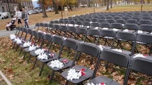Pedestrians pass by the Covid-19 Empty Chair Memorial on display at Campagnone Common in Lawrence, Massachusetts, US. Each chair represents a person from Lawrence who has died from coronavirus.(AP) Pedestrians pass by the Covid-19 Empty Chair Memorial on display at Campagnone Common in Lawrence, Massachusetts, US. Each chair represents a person from Lawrence who has died from coronavirus.(AP)