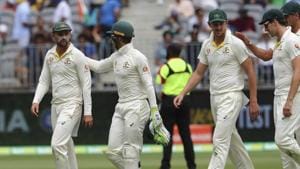 Australia's Nathan Lyon, left, is congratulated by skipper Tim Paine after he took five wickets in India's first innings in the second cricket test between Australia and India in Perth, Australia, Sunday, Dec. 16, 2018. (AP Photo/Trevor Collens)(AP)