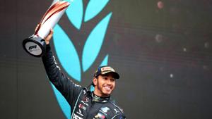 Formula One F1 - Turkish Grand Prix - Istanbul Park, Istanbul, Turkey - November 15, 2020 Mercedes' Lewis Hamilton celebrates on the podium with a trophy after winning the race and the world championship Pool via REUTERS/Tolga Bozoglu(Pool via REUTERS) Formula One F1 - Turkish Grand Prix - Istanbul Park, Istanbul, Turkey - November 15, 2020 Mercedes' Lewis Hamilton celebrates on the podium with a trophy after winning the race and the world championship Pool via REUTERS/Tolga Bozoglu(Pool via REUTERS)