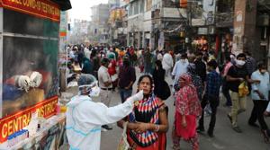 A healthcare worker collects a swab sample from a woman amidst the spread of the coronavirus disease (COVID-19), at a market, in the old quarters of Delhi.(Reuters) A healthcare worker collects a swab sample from a woman amidst the spread of the coronavirus disease (COVID-19), at a market, in the old quarters of Delhi.(Reuters)