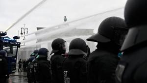 Police use a water cannon to disperse protesters demonstrating against measures imposed by the German government to limit the spread of the novel coronavirus.(AFP) Police use a water cannon to disperse protesters demonstrating against measures imposed by the German government to limit the spread of the novel coronavirus.(AFP)