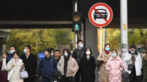 People walk along a street in Beijing on November 19.(AFP) People walk along a street in Beijing on November 19.(AFP)