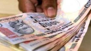 A customer deposits cash at a bank in Mumbai in this file photo. Traders said sustained foreign fund inflows into the domestic equity markets also helped the local unit.(AFP Photo) A customer deposits cash at a bank in Mumbai in this file photo. Traders said sustained foreign fund inflows into the domestic equity markets also helped the local unit.(AFP Photo)