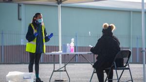 A woman is instructed how to perform a self Covid-19 test at a testing centre at Liverpool Tennis Centre in Liverpool, UK in this file photo.(Bloomberg Photo) A woman is instructed how to perform a self Covid-19 test at a testing centre at Liverpool Tennis Centre in Liverpool, UK in this file photo.(Bloomberg Photo)