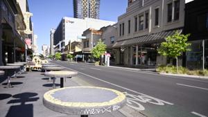 Tables stand vacant in a nearly empty pedestrian mall in Adelaide, Australia on Thursday.(AP Photo) Tables stand vacant in a nearly empty pedestrian mall in Adelaide, Australia on Thursday.(AP Photo)