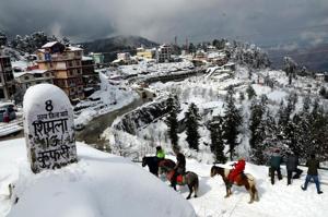 Tourists enjoying a pony ride on a snow-capped trail at Kufri near Shimla after the last spell earlier this week.(Deepak Sansta/HT)