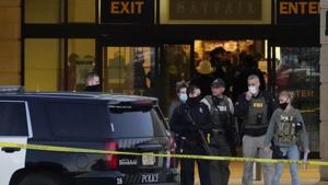 FBI officials and police stand outside the Mayfair Mall after a shooting.(AP) FBI officials and police stand outside the Mayfair Mall after a shooting.(AP)