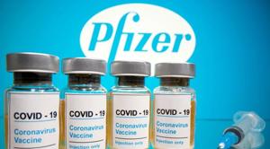Vials with a sticker reading, "Covid-19 / Coronavirus vaccine / Injection only" and a medical syringe are seen in front of a displayed Pfizer logo in this illustration taken October 31, 2020. REUTERS/Dado Ruvic Vials with a sticker reading, "Covid-19 / Coronavirus vaccine / Injection only" and a medical syringe are seen in front of a displayed Pfizer logo in this illustration taken October 31, 2020. REUTERS/Dado Ruvic