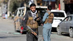 A police officer stands guard after rockets hit residential areas in Kabul, Afghanistan.(REUTERS) A police officer stands guard after rockets hit residential areas in Kabul, Afghanistan.(REUTERS)