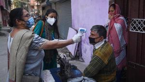 District administration personnel thermal screening people during door to door Covid-19 surveys at Raghubir Nagar in New Delhi.(Sanchit Khanna/HT PHOTO) District administration personnel thermal screening people during door to door Covid-19 surveys at Raghubir Nagar in New Delhi.(Sanchit Khanna/HT PHOTO)