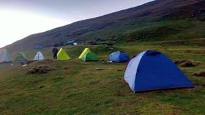 Camping tents set up on Khaliya Bugyal (meadow) in Pithoragarh. Camping and bonfires on the meadows lead to soil erosion and pollution on the otherwise clean land, according to forest officials.(HT PHOTO.)