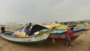 Fishermen cover their boats at Marina Beach during heavy rain, triggered by Cyclone Nivar,in Chennai.(PTI) Fishermen cover their boats at Marina Beach during heavy rain, triggered by Cyclone Nivar,in Chennai.(PTI)